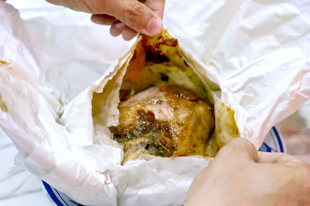 The ‘grand opening’ – unwrapping the Paper Baked Chicken. — Picture by CK Lim