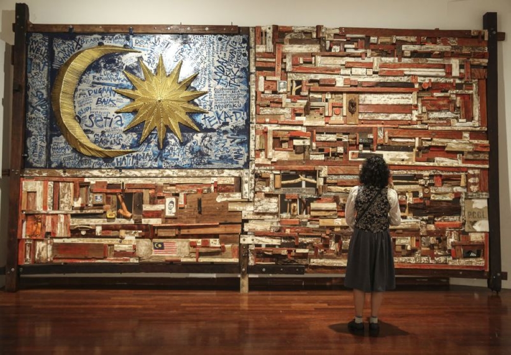 A woman looks at the artwork titled ‘Dirgahayu Negaraku’ by Mohamad Ismadi Sallehudin during the Kuala Lumpur Biennale 2017 event at the National Visual Art Gallery in Kuala Lumpur November 29, 2017. — Picture by Yusof Mat Isa