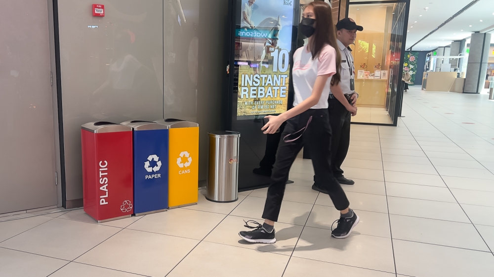 Recycling bins places in shopping complexes for waste separation can be located at most malls today. — Picture by Raymond Manuel