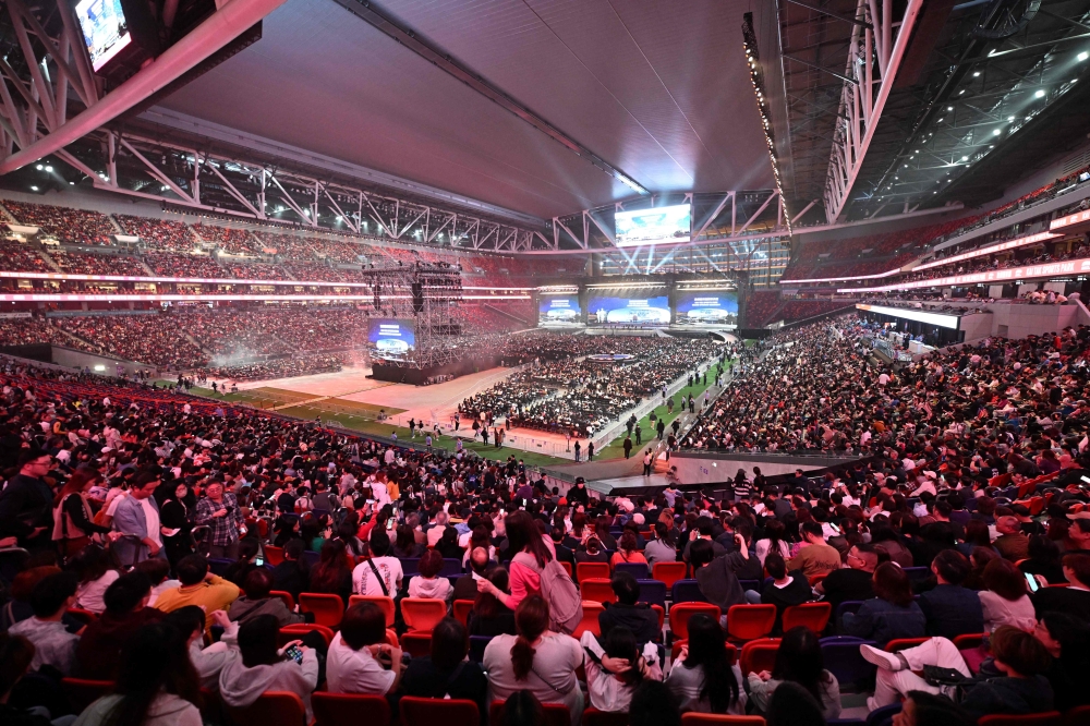 The crowd watches the opening ceremony of the Kai Tak Sports Park. — AFP pic