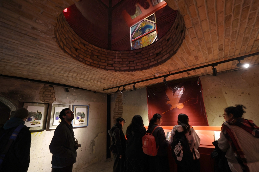 People visit an exhibition by Iranian artist Mimi Amini at the Argo Factory, a contemporary art museum and cultural centre, housed in a former brewery in Tehran, on February 5, 2025. — AFP pic