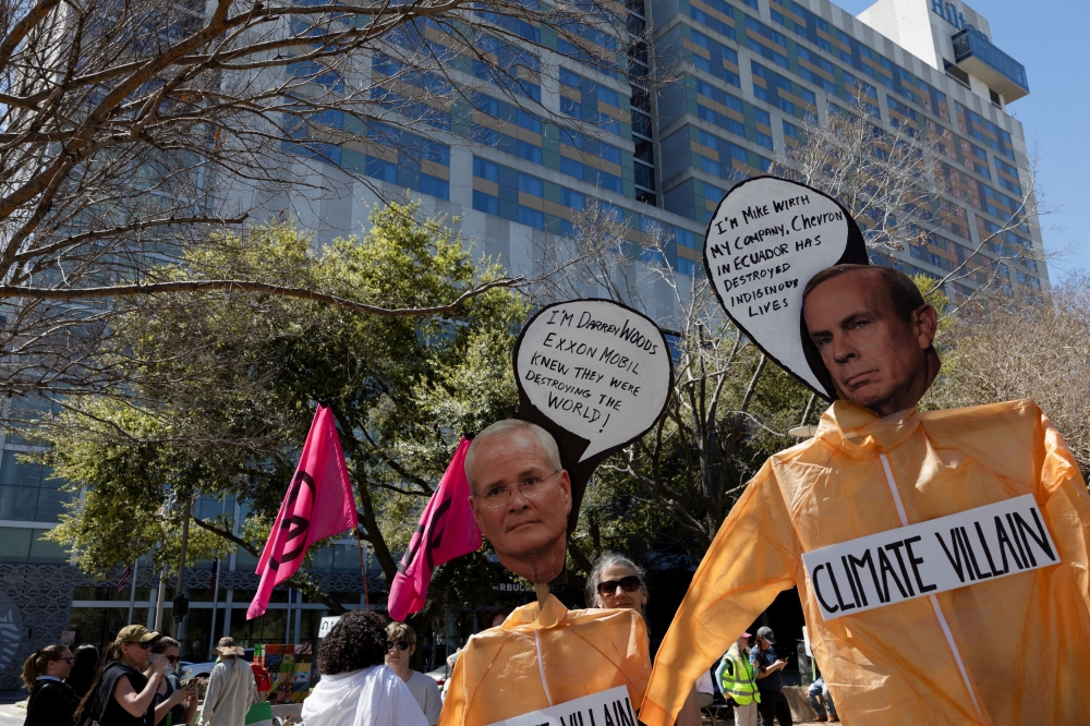 Climate protesters criticise energy executives and developments outside the CERAWeek venue in Houston, Texas, U.S., March 10, 2025. — Reuters pic