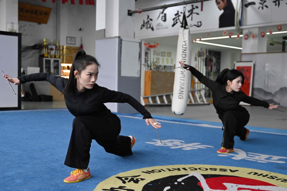 This photo taken on February 21, 2025 shows Duan Ruru and Liu Qiao demonstrating their martial art movements. — AFP pic 